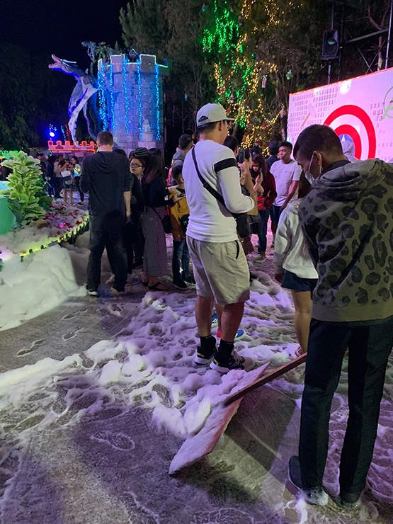 A person scraping bubble snow at Baguio Christmas Village