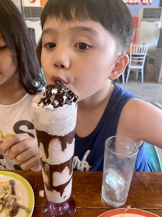 Spice Jar - Happy kid eating chocolate shake from Spice Jar